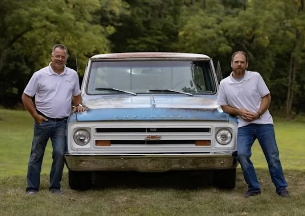 Executive Collision team members with a classic Chevrolet truck